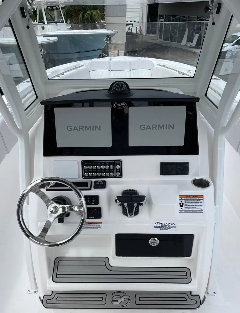 Slide: The Image of 2024 Sea Fox 288 Commander helm with dual Garmin displays and steering wheel. - 7