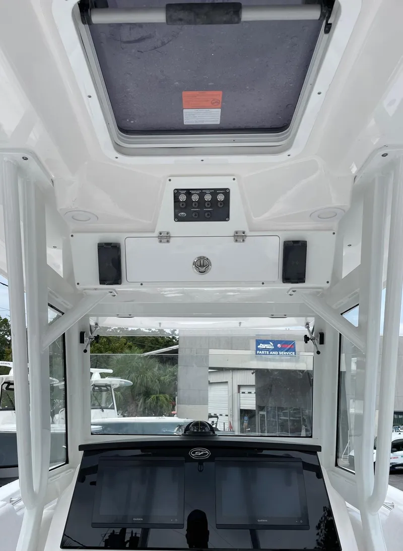 Slide: The Image of 2024 Sea Fox 288 Commander boat interior with control panel and overhead hatch. - 9
