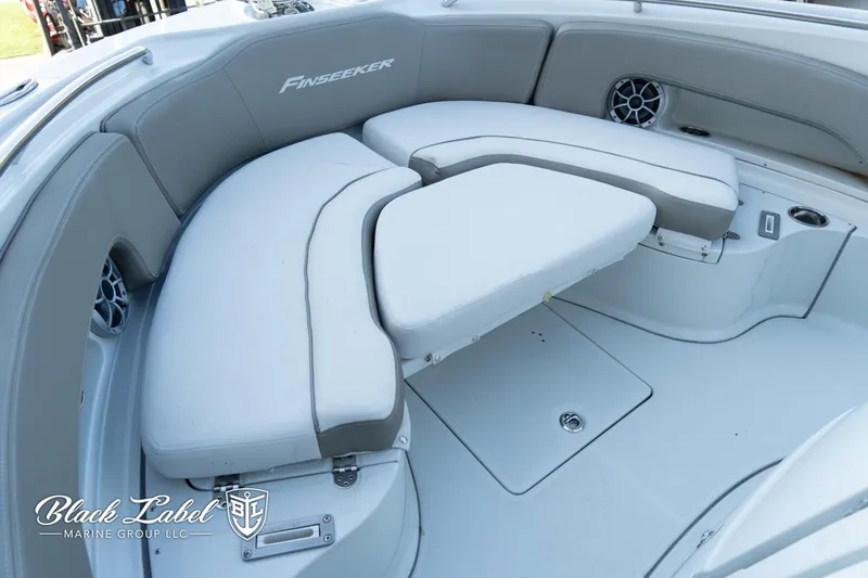 Slide: The Image of 2024 Finseeker 230 boat interior with cushioned seating and storage compartments. - 15