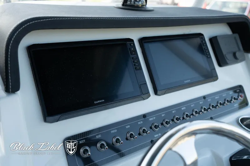 Slide: The Image of 2024 Finseeker 230 dashboard with dual Garmin displays and control panel. - 21