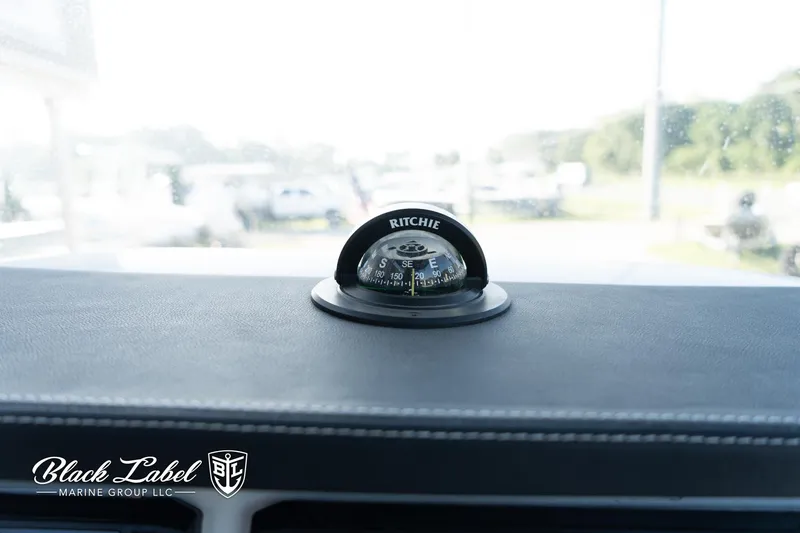 Slide: The Image of 2024 Finseeker 230 dashboard with Ritchie compass, Black Label Marine Group branding. - 24