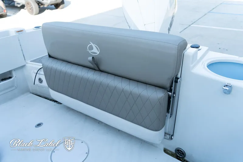 Slide: The Image of 2024 Finseeker 230 boat seat with diamond-patterned upholstery, featuring Black Label Marine Group logo. - 26