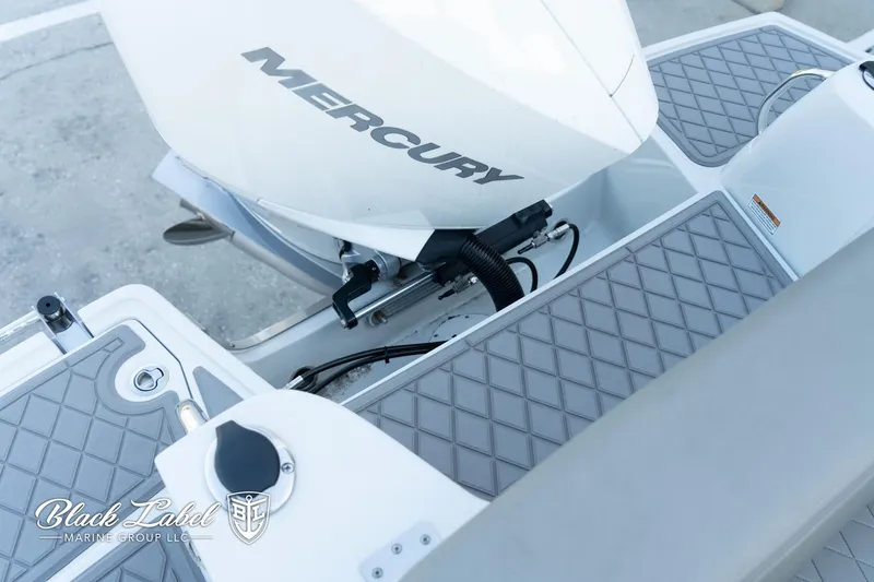 Slide: The Image of 2024 Finseeker 230 boat with Mercury engine, featuring diamond-patterned deck. - 28