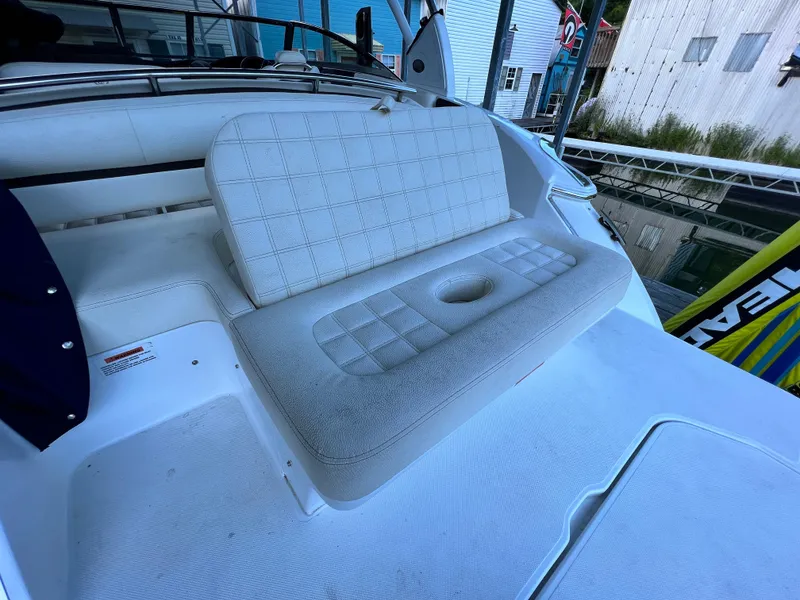Slide: The Image of 2021 Cobalt R5 boat interior with white cushioned seating and cup holder. - 11