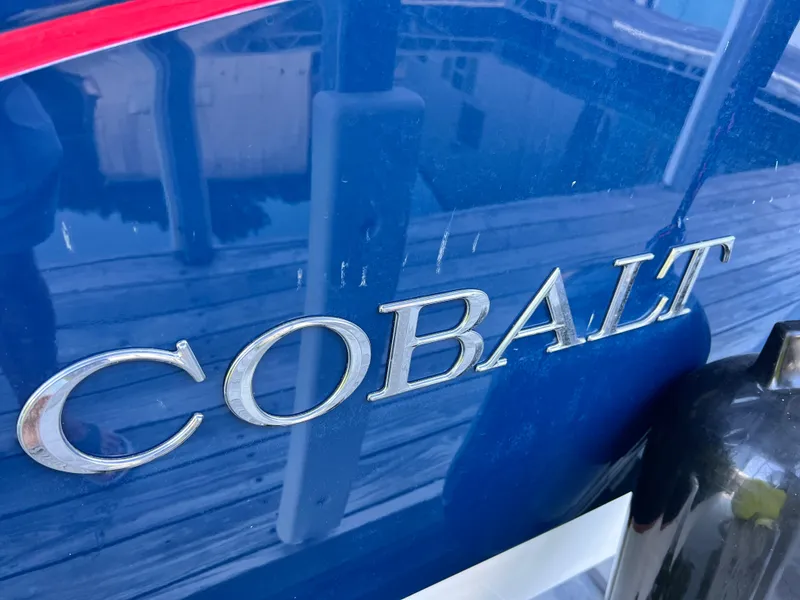 Slide: The Image of Close-up of 2021 Cobalt R5 boat nameplate in silver on blue hull. - 22