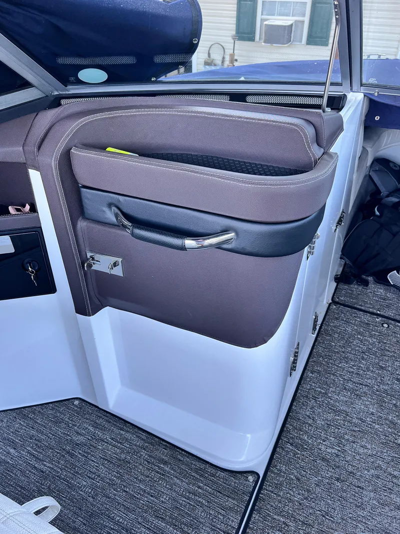 Slide: The Image of Interior of a 2021 Cobalt R5 boat showing storage compartment and seating area. - 23
