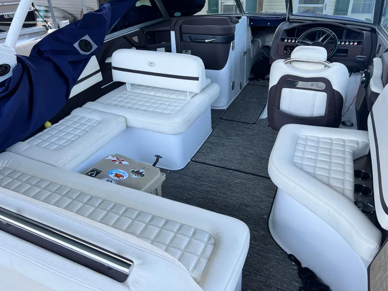 Slide: The Image of Interior of a 2021 Cobalt R5 boat with white seating and modern dashboard. - 4