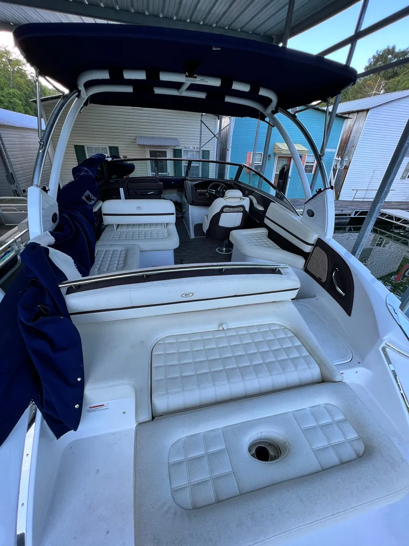 Slide: The Image of 2021 Cobalt R5 boat interior with white seating and blue canopy. - 5