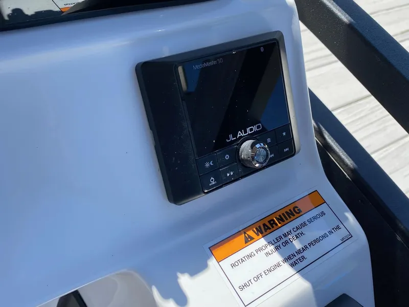Slide: The Image of JL Audio control panel on 2023 JC Neptoon Sport 23TT boat dashboard. - 16