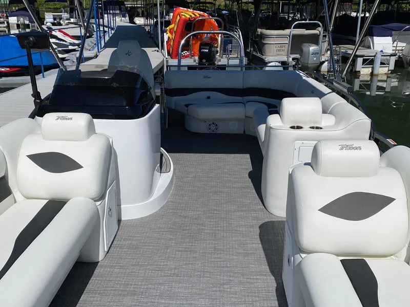 Slide: The Image of 2023 JC Neptoon Sport 23TT pontoon boat interior with white seating and modern design. - 5