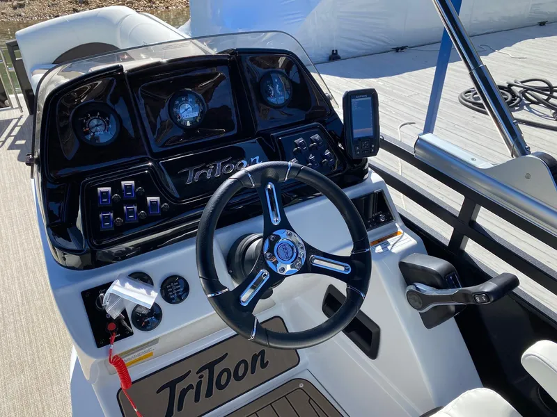 Slide: The Image of 2024 JC NEPTOON SPORT 21TT boat dashboard with steering wheel and control panel. - 12