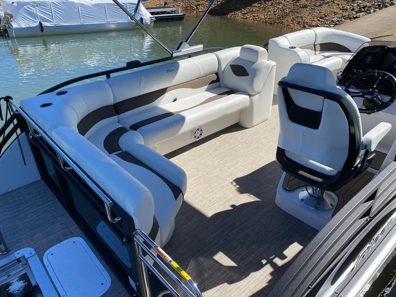 Slide: The Image of 2024 JC NEPTOON SPORT 21TT pontoon boat interior with plush seating and captain's chair. - 13
