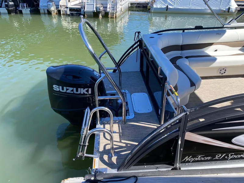 Slide: The Image of 2024 JC Neptoon Sport 21TT pontoon boat with Suzuki outboard motor at dock. - 14