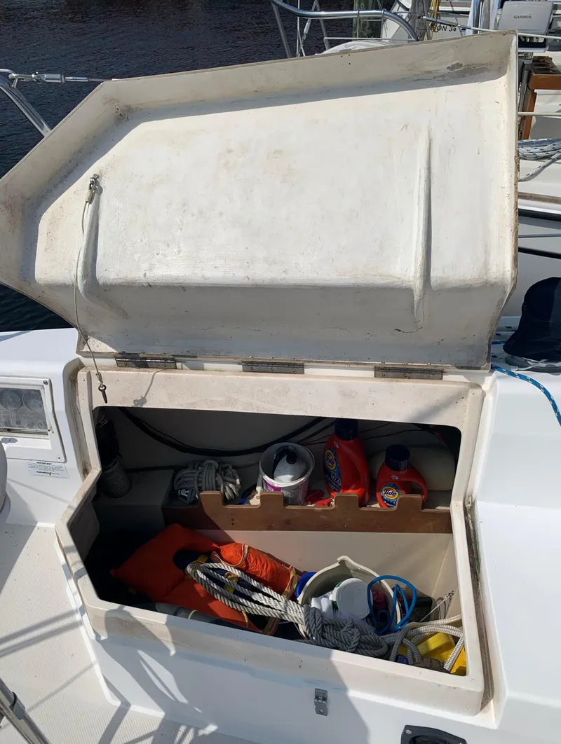 Slide: The Image of Open storage compartment on a 1987 Catalina 30 Tall-Rig sailboat with various boating supplies. - 18