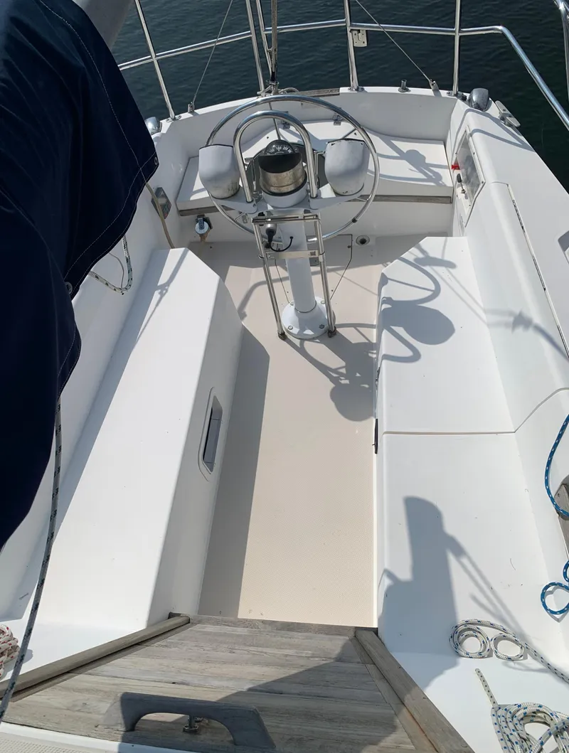 Slide: The Image of 1987 Catalina 30 Tall-Rig sailboat cockpit with steering wheel and seating. - 19