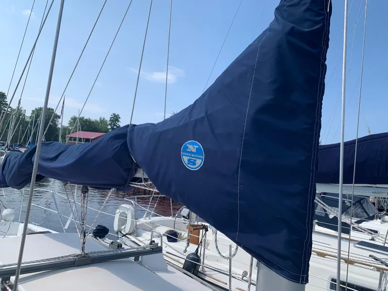 Slide: The Image of 1987 Catalina 30 Tall-Rig sailboat with blue sail cover docked at marina. - 26