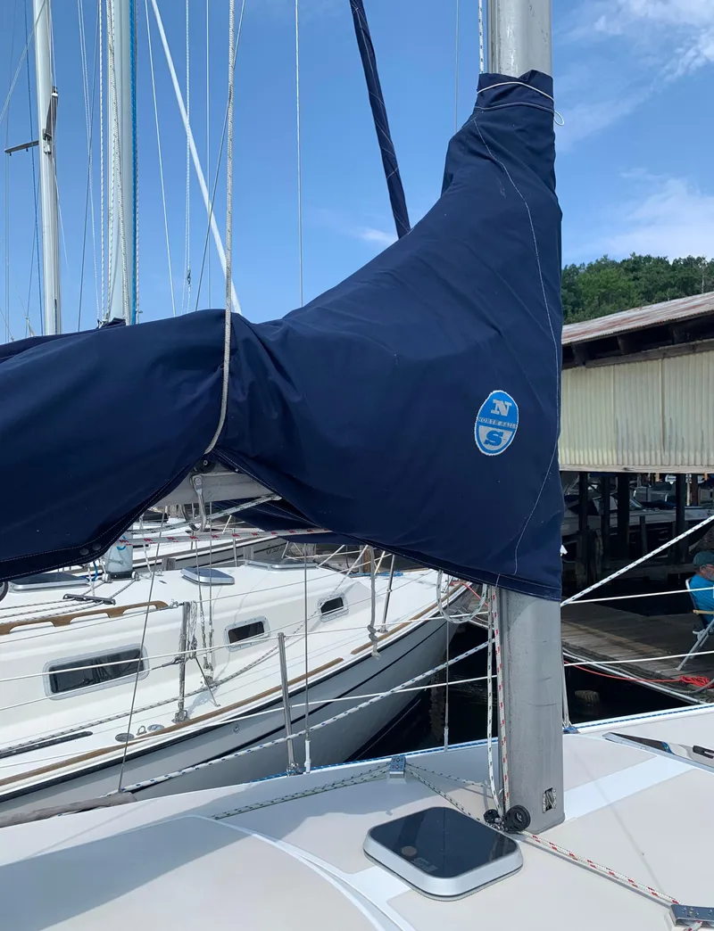 Slide: The Image of 1987 Catalina 30 Tall-Rig sailboat mast and sail cover at marina. - 27