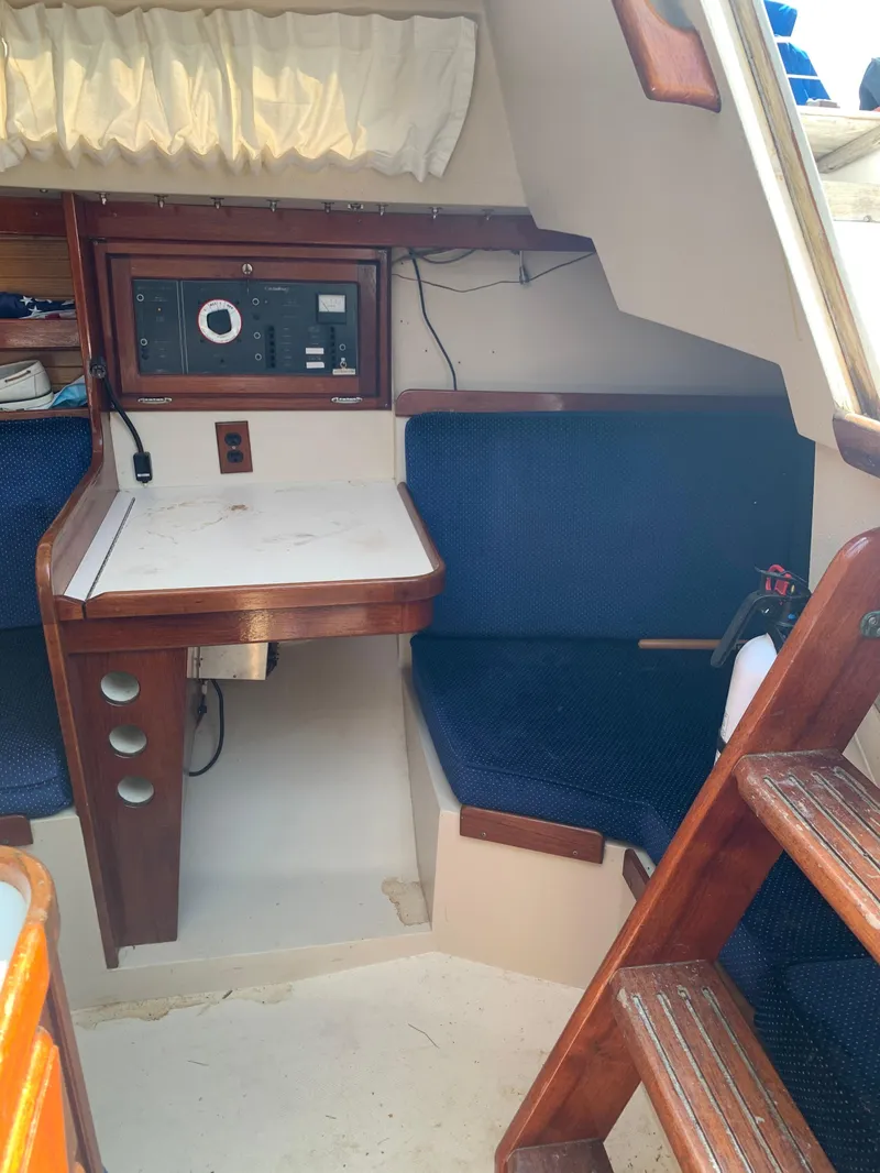 Slide: The Image of Interior of 1987 Catalina 30 Tall-Rig sailboat with navigation station and seating. - 36