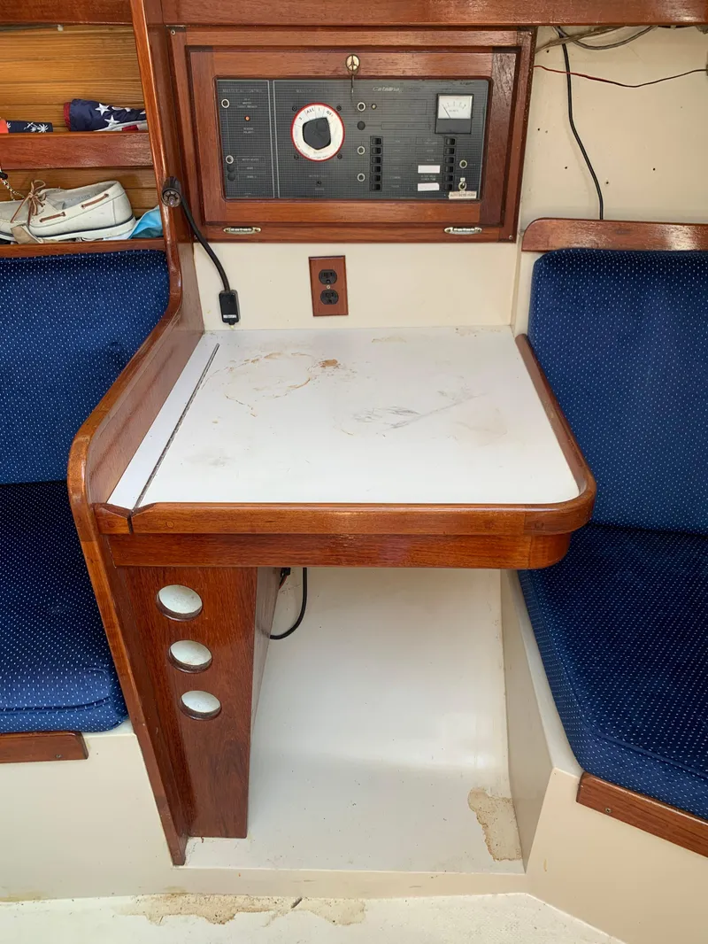 Slide: The Image of Navigation station on a 1987 Catalina 30 Tall-Rig sailboat with control panel and seating. - 37