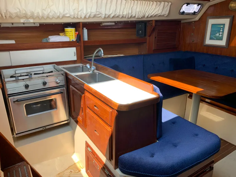 Slide: The Image of Interior of 1987 Catalina 30 Tall-Rig sailboat with kitchen and dining area. - 42