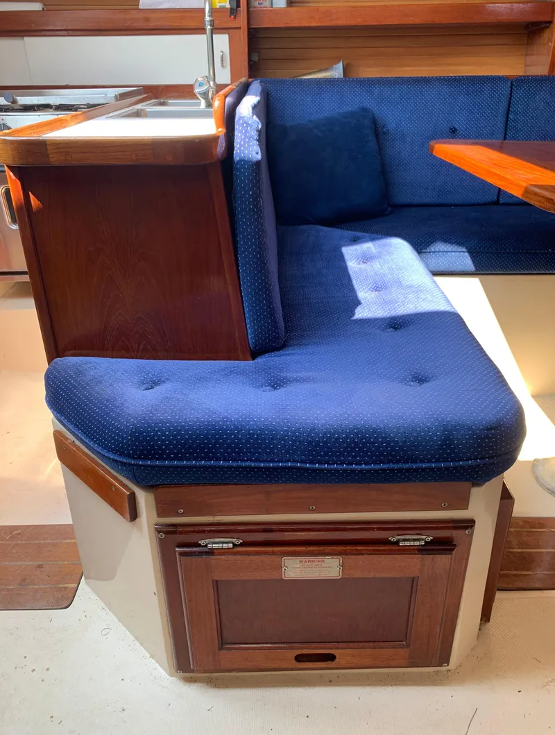 Slide: The Image of Interior seating area of a 1987 Catalina 30 Tall-Rig sailboat with blue cushions. - 43