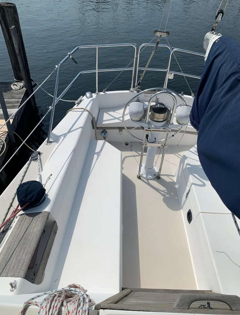 Slide: The Image of 1987 Catalina 30 Tall-Rig sailboat cockpit with steering wheel and seating. - 6