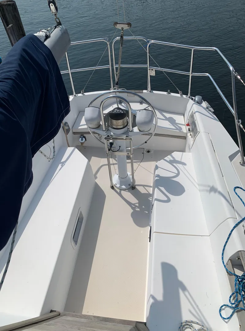 Slide: The Image of 1987 Catalina 30 Tall-Rig sailboat cockpit with steering wheel and seating. - 7