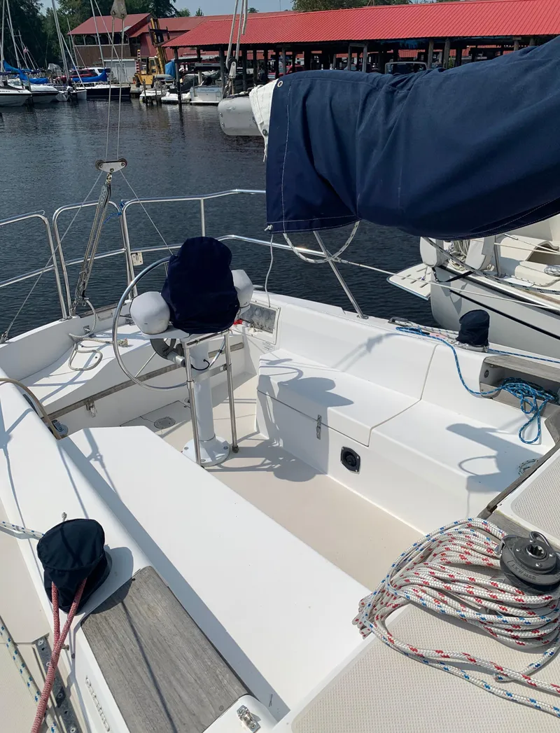 Slide: The Image of 1987 Catalina 30 Tall-Rig sailboat cockpit with marina background. - 8