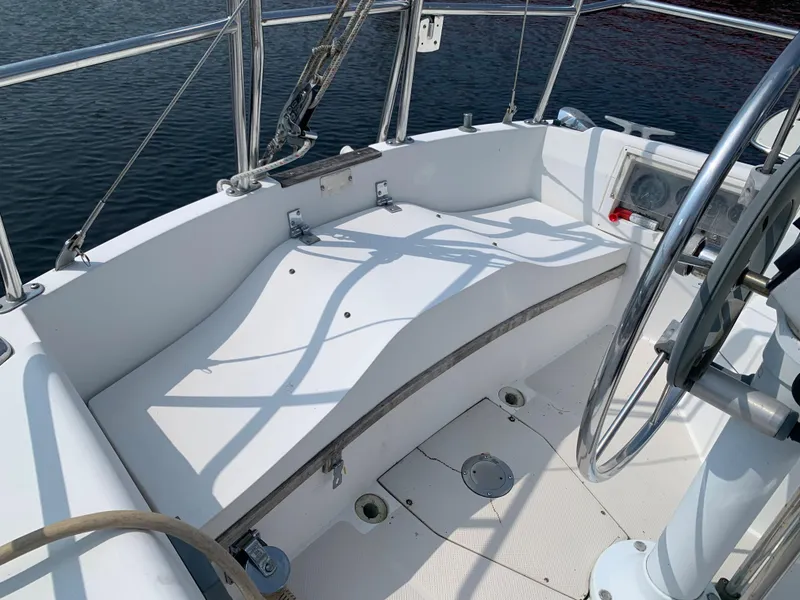 Slide: The Image of Cockpit of 1987 Catalina 30 Tall-Rig sailboat with steering wheel and seating. - 9