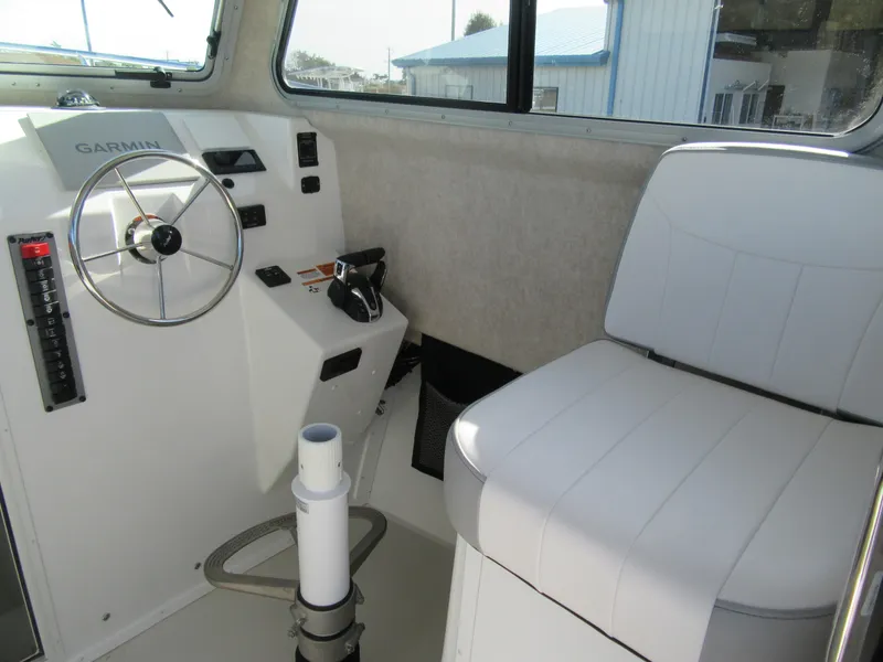 Slide: The Image of 2024 Parker 2820 XLD Sport Cabin interior helm with Garmin controls and seating. - 5