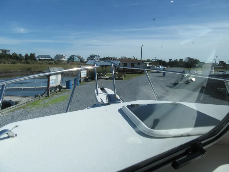 Slide: The Image of View from the Parker 2820 XLD Sport Cabin boat, 2024 model, docked near a marina. - 6