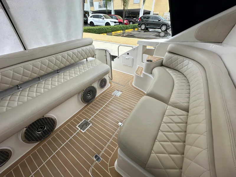 Slide: The Image of 2007 Regal 4460 Commodore boat interior with beige leather seating and wood flooring. - 10