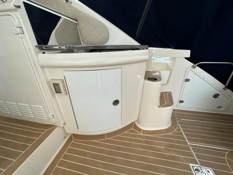 Slide: The Image of 2007 Regal 4460 Commodore boat interior with white cabinetry and tan flooring. - 11
