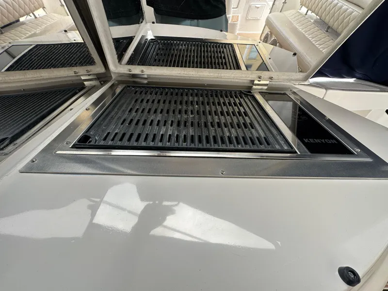 Slide: The Image of 2007 Regal 4460 Commodore boat grill and seating area. - 12