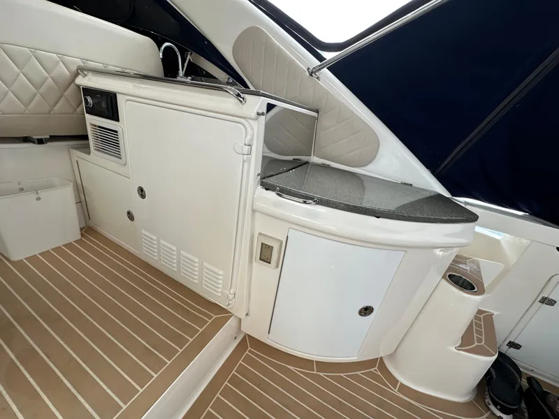 Slide: The Image of 2007 Regal 4460 Commodore yacht interior with kitchenette and seating area. - 14