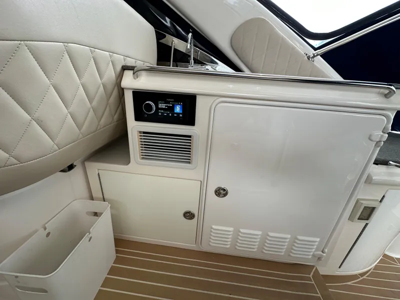 Slide: The Image of Interior of 2007 Regal 4460 Commodore yacht with white cabinetry and control panel. - 15