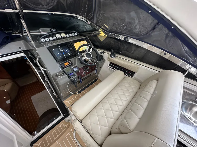 Slide: The Image of 2007 Regal 4460 Commodore boat helm with modern controls and luxurious seating. - 16