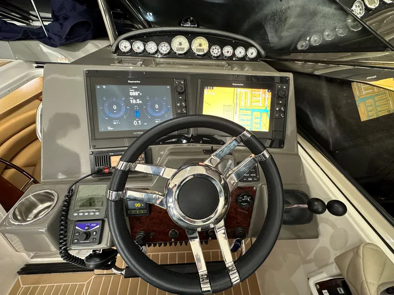 Slide: The Image of 2007 Regal 4460 Commodore boat dashboard with steering wheel, navigation screens, and control instruments. - 17