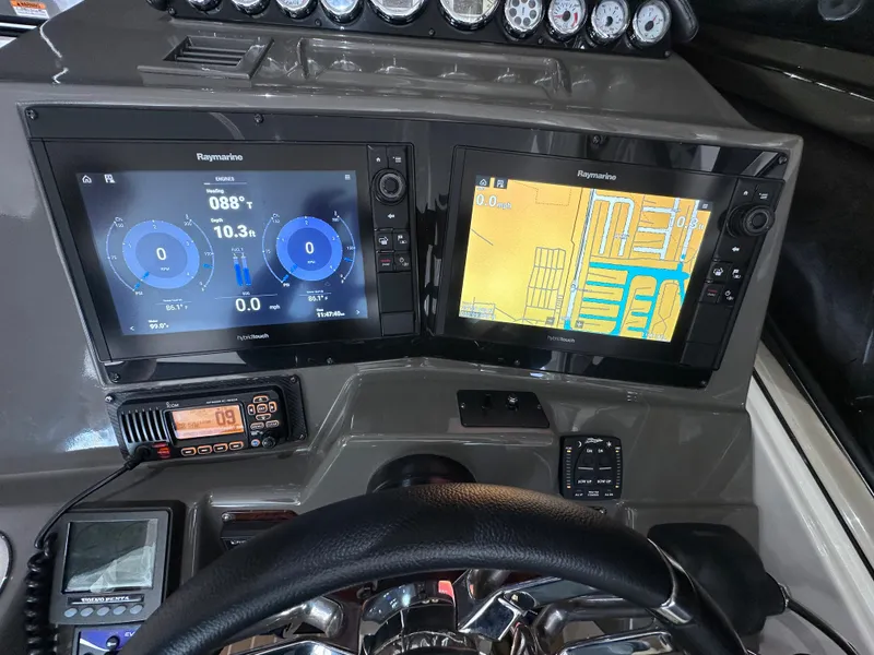 Slide: The Image of 2007 Regal 4460 Commodore dashboard with Raymarine navigation displays and controls. - 18