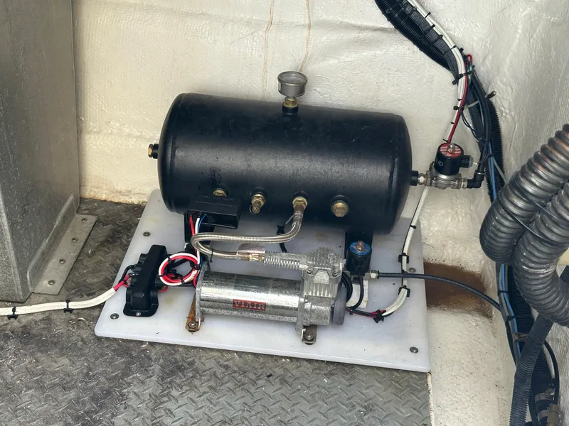 Slide: The Image of 2007 Regal 4460 Commodore engine compartment with air compressor and wiring. - 25