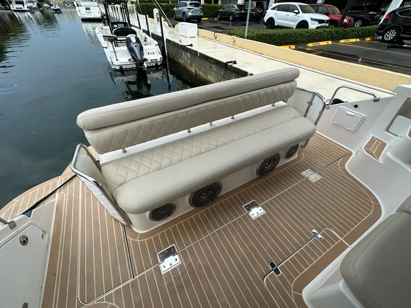 Slide: The Image of 2007 Regal 4460 Commodore boat with beige seating and wood-patterned deck. - 28