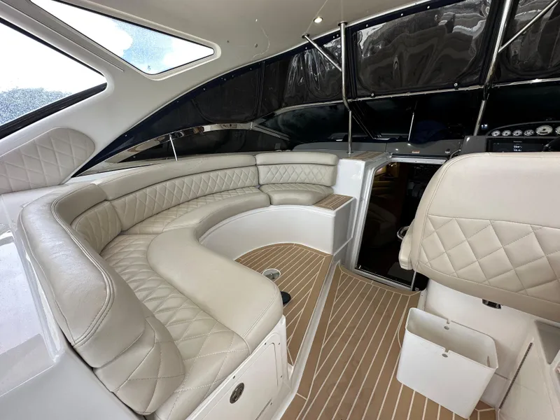 Slide: The Image of 2007 Regal 4460 Commodore yacht interior with beige leather seating and wood flooring. - 30