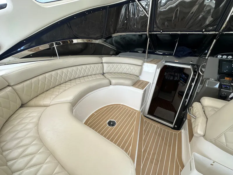 Slide: The Image of 2007 Regal 4460 Commodore yacht interior with beige leather seating and wood flooring. - 31