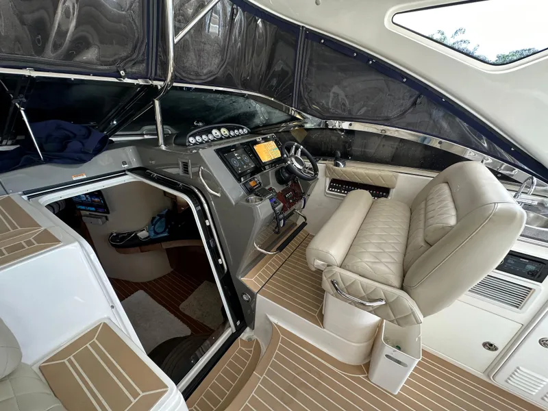 Slide: The Image of 2007 Regal 4460 Commodore yacht interior with helm station and seating. - 32