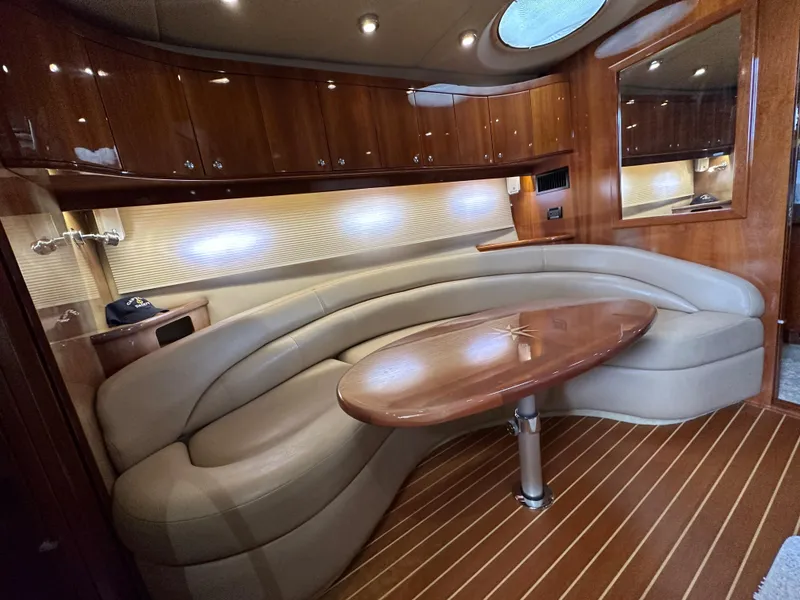 Slide: The Image of Luxurious interior of a 2007 Regal 4460 Commodore yacht with leather seating and wooden table. - 35