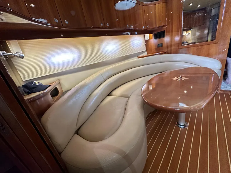 Slide: The Image of Luxurious interior of 2007 Regal 4460 Commodore yacht with curved leather seating and wooden table. - 36