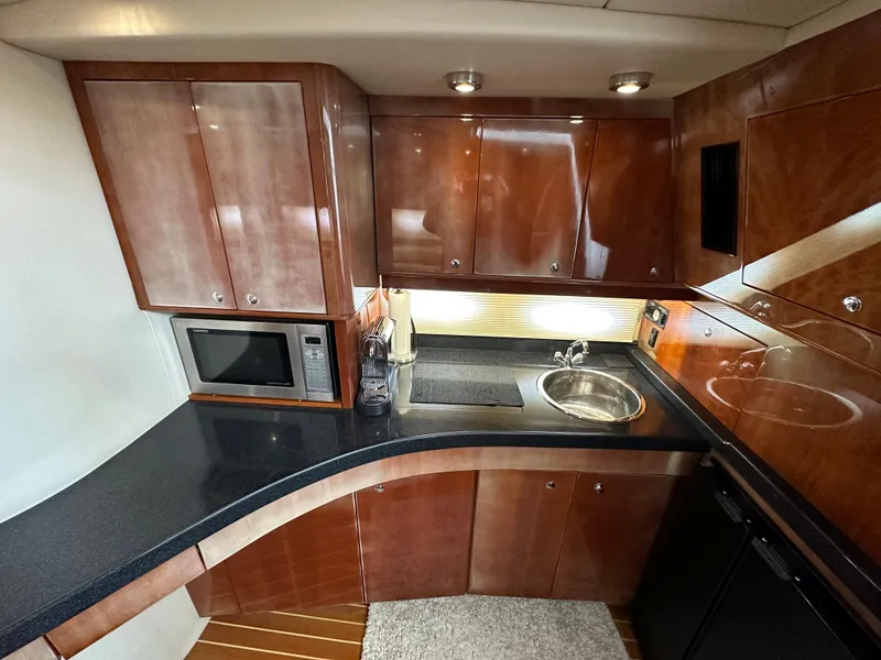 Slide: The Image of Luxurious 2007 Regal 4460 Commodore yacht kitchen with sleek cabinetry and modern appliances. - 38