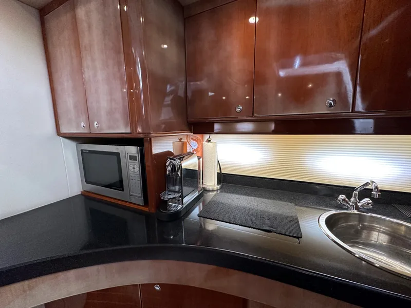 Slide: The Image of 2007 Regal 4460 Commodore yacht kitchen with microwave, coffee maker, and sink. - 39