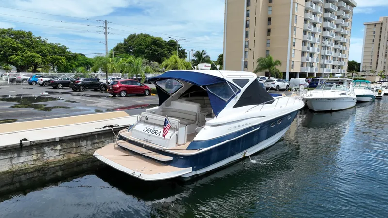 Slide: The Image of 2007 Regal 4460 Commodore yacht docked in a marina with buildings in the background. - 4