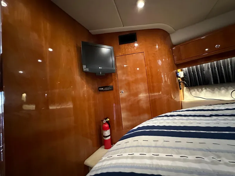 Slide: The Image of Interior cabin of 2007 Regal 4460 Commodore yacht with TV and fire extinguisher. - 42